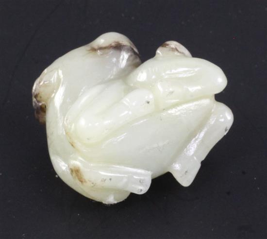 A Chinese white and black jade figure of a buffalo, in recumbent pose, 3.4cm